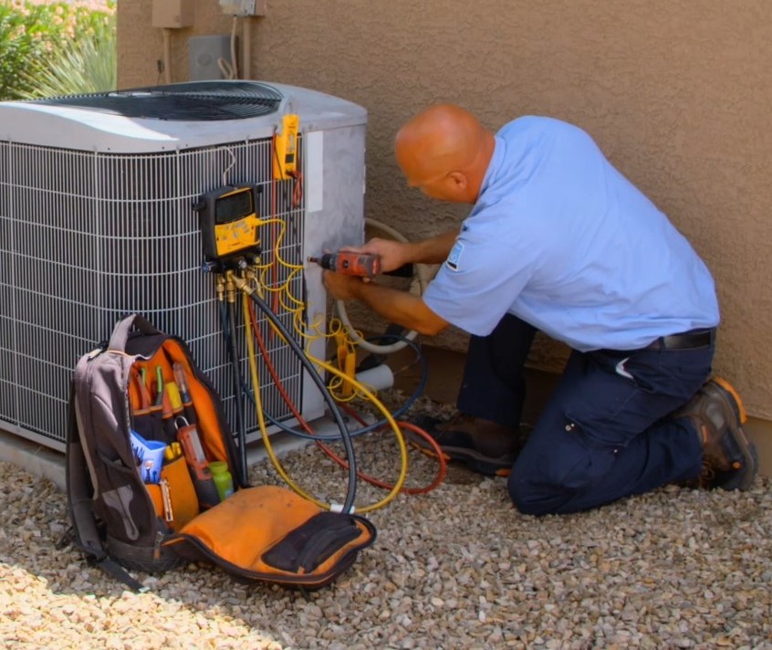 D&H AC - Myle HVAC Technician repairing an AC unit in a home in Tucson