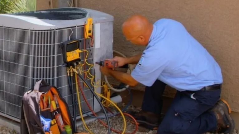 D&H HVAC tech conducting AC repairs.