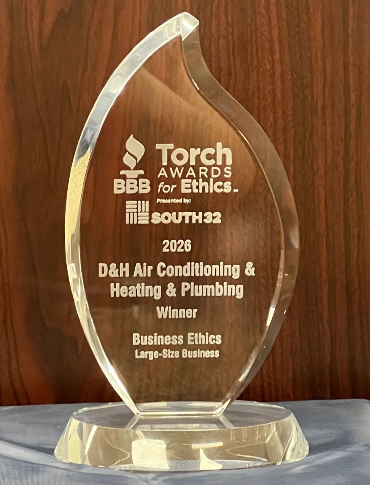Crystal trophy reading 'Torch Awards for Ethics' presented by BBB and South32, 2026 winner: D&H Air Conditioning & Heating & Plumbing, Large-Size Business ethics