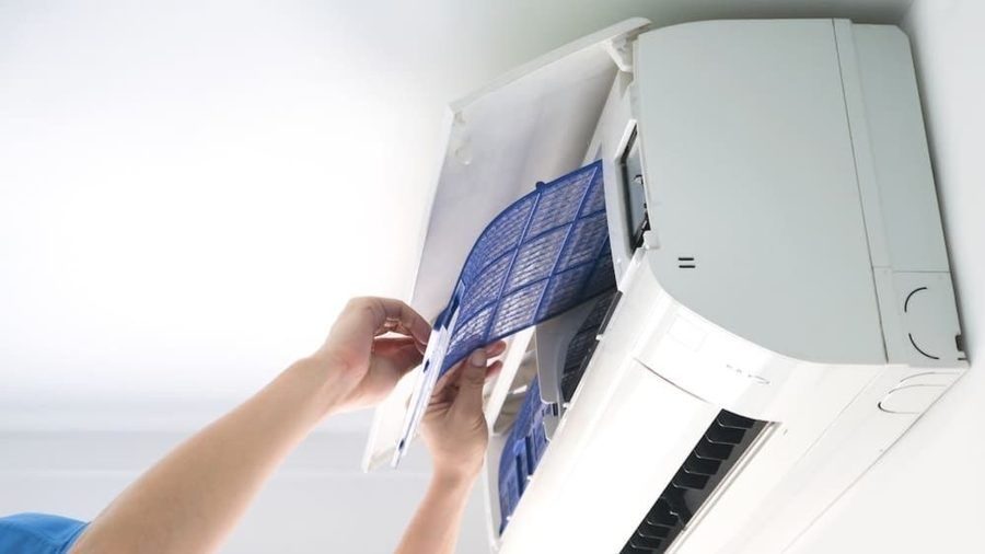HVAC tech opening ductless mini split unit to inspect.