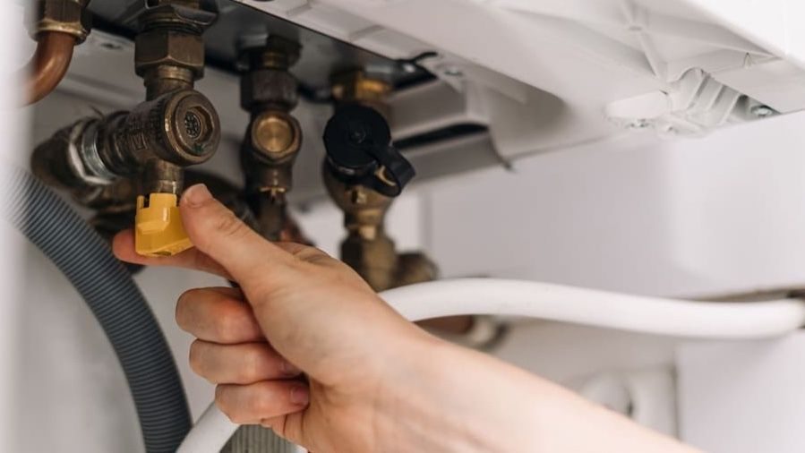 HVAC tech repairing heater.