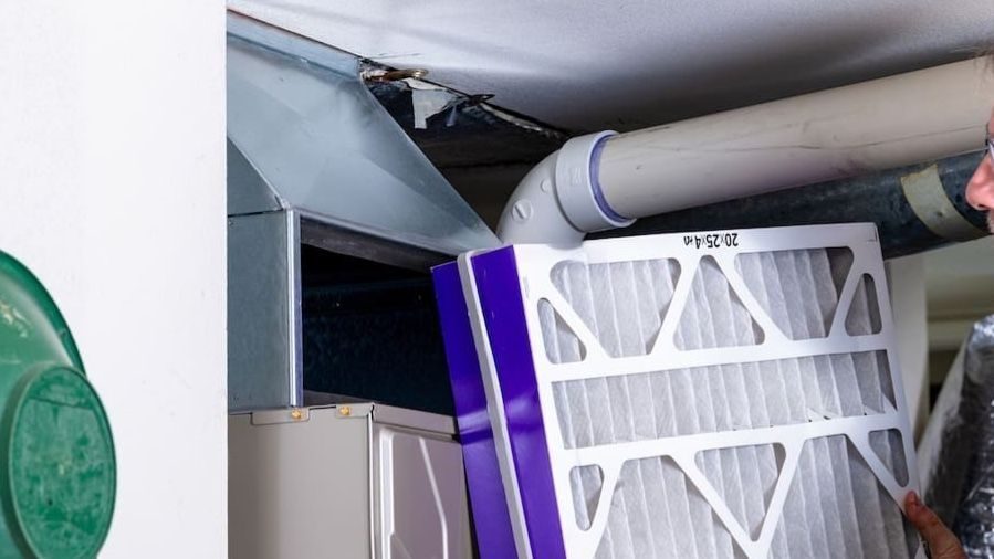 HVAC tech replacing filters as part of heating maintenance.