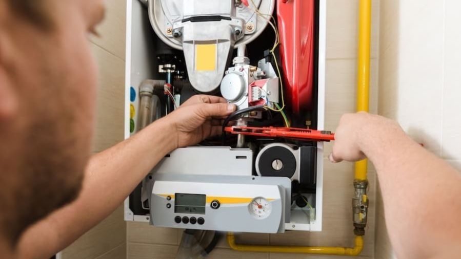 HVAC tech repairing open furnace.