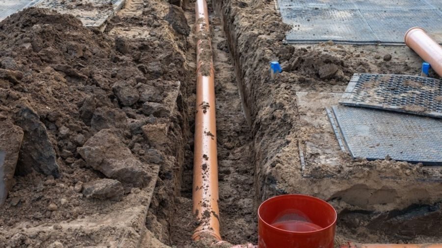 Open sewer line in ground.